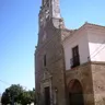 Ermita del Cristo de Villanueva del Campo, con su torre de piedra, bajo un cielo azul
